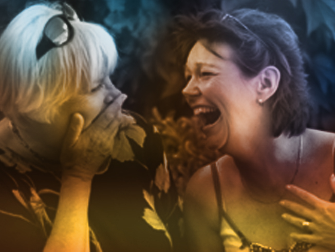 Two ladies laughing together.